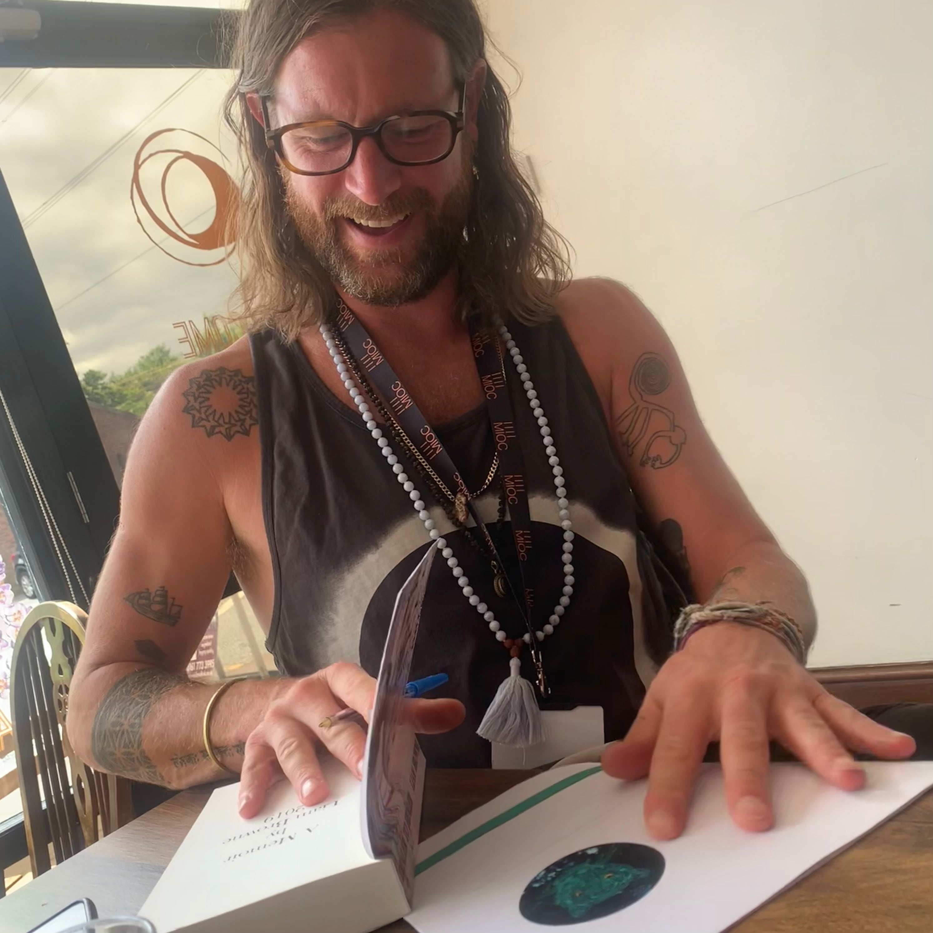 Photo of Liam signing his book from Dealer to Healer